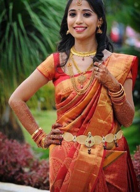 South indian bride in red kanjivaram silk saree for Heavy Wedding Party Saree